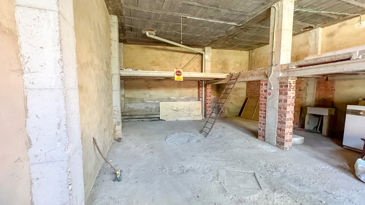 Street-level garage with storage mezzanine